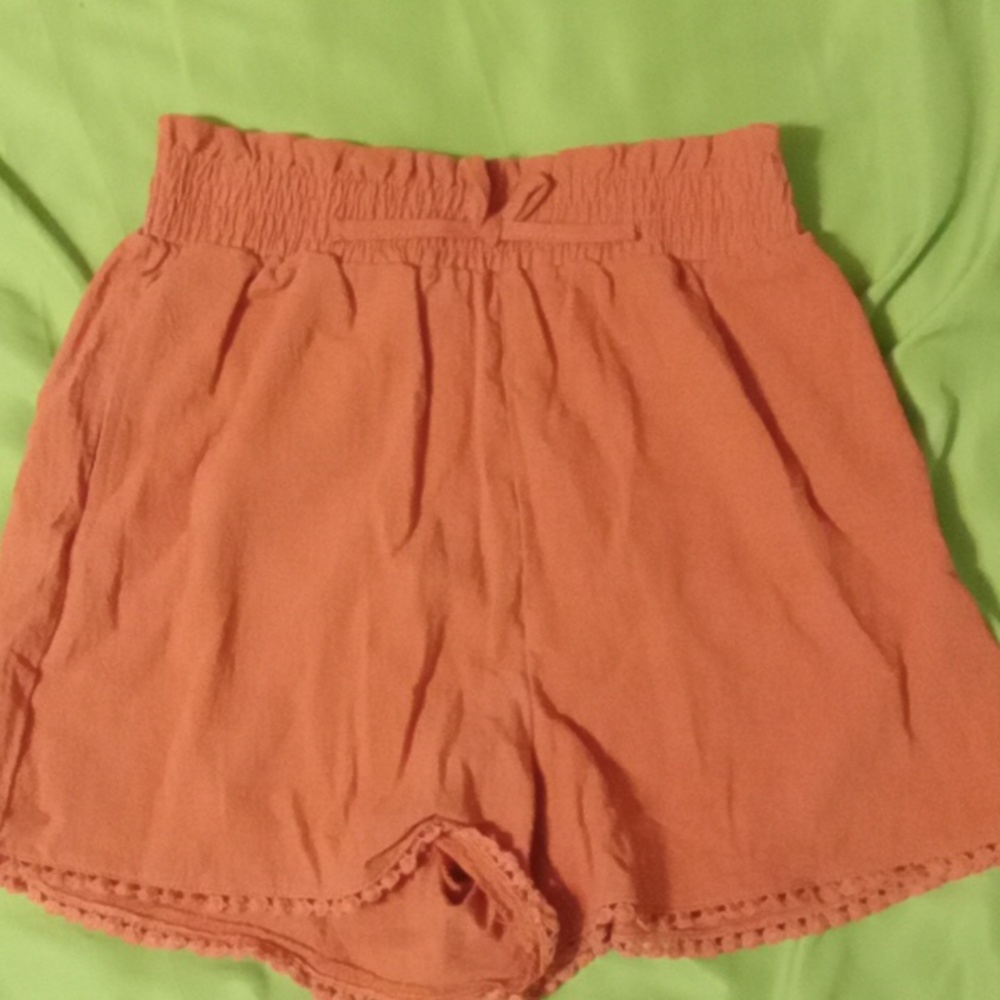 Burnt orange high waist shorts.